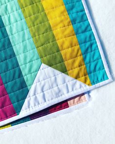 a close up of a piece of fabric with a rainbow design on the top and bottom