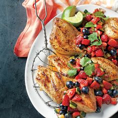 a plate with chicken, fruit and cilantro garnish