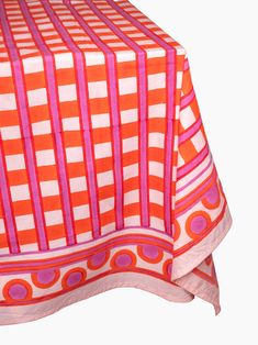 an orange and pink table cloth with circles on it