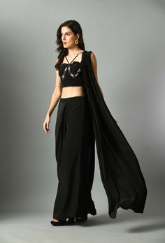 The Nur Bustier with Moonshine pre draped saree is a luxurious statement piece, crafted with fine crepe silk and our pre-draped saree in black and it is elegant and fuss-free and detailed embroidery on bustier. The black color adds a stylish twist to any look and the silk provides a lightweight feel with long-lasting comfort.Composition and care Crepe silk Hand wash or dry clean only GARMENT MEASUREMENTS Size Bust Waist Hip Neck Shoulder Arm Hole XS 32” 26” 35” 13” 14” 13” S 34” 28” 37” 13.5” 14.5” 14” M 36” 30” 39” 14.5” 15” 15” L 38” 32” 41” 15.5” 15.5” 16” XL 40” 34” 43” 16.5” 16 17” Ships Worldwide from India.MADE IN INDIA Designer Black Draped Saree, Black Georgette Draped Saree, Black Draped Georgette Saree, Pre-draped Side Open Saree For Party, Traditional Black Draped Saree, Black Draped Saree With Sheer Dupatta, Black Bollywood Style Pre-draped Saree, Black Bollywood Pre-draped Saree, Elegant Draped Choli With Draped Sleeves