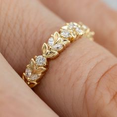 a close up view of a gold ring with diamonds