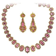 A demi-parure, "parure" meaning "adorn" in French, is a partial set of matching jewelry designed to be worn en suite. This incredible handcrafted pink topaz necklace and earring set is from the early Georgian (ca1750s) era and comprised of a riviera style necklace and a pair of complementary day-to-night earrings. The necklace features 41 graduated and faceted oval-shaped pink topaz stones that look stunning against their 18kt yellow gold, foil-back collet settings. The glittering topaz stones display various shades of pale to light pinks, each link encircled by a brilliant beaded sunburst motif. A secure clasp is incorporated into the design, hidden beneath a pink topaz link, and a hidden hook bail is found behind the central link. The necklace drapes beautifully against the wearer's neck Rococo Jewelry, Pink Topaz Necklace, Regency Jewelry, Riviera Style, Regency Gown, Fruit Necklace, Iron Jewelry, Georgian Jewelry, Art Nouveau Pendant