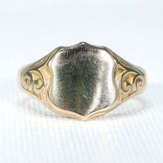 I know class rings are a thing, and I'm in no way opposed, but when the young men in my family graduate from college, I give them a ring just like this one. There is something about a ring like this one that makes young men look, well, manly. Do you know an upcoming graduate? Send him out into the world right, with a bespoke suit, a pair of well made wingtips and a ring like this. This wonderful Edwardian version of the signet ring was hand crafted in Birmingham, England in 1915. The top is a sh Antique Dome Ring Stamped 14k As Gift, Classic Yellow Gold Signet Ring With Maker's Mark, Vintage White Gold Signet Ring Stamped 14k, Victorian Engraved Oval Ring, Victorian Oval Engraved Ring, 14k Gold Signet Ring With Maker's Mark As Gift, Heirloom 14k Gold Signet Ring With Maker's Mark, Victorian Style Yellow Gold Signet Ring With Polished Finish, Victorian 14k Gold Ring With Engraving Option