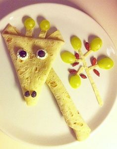 a white plate topped with two slices of pizza and olives on top of it