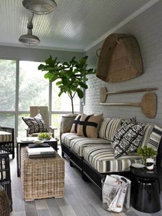 a living room filled with furniture and a potted plant