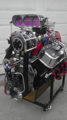 an engine is shown on a stand in front of a garage