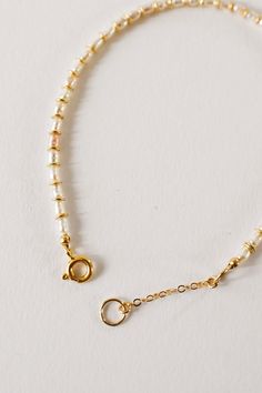 A bracelet version of the beloved Petite Pearl Choker. Tiny freshwater pearls and individually hammered gold fill spacer beads adorn this delicate bracelet! Layer it with these others, or wear it alone. 7" + 1" extender Handmade in Rockaway Beach Gold Pearl Single Strand Beaded Bracelets, Everyday Gold Single Strand Pearl Bracelet, Adjustable 14k Gold Filled Pearl Bracelet With Gold Beads, Gold Pearl Bracelet With Extender, 14k Gold-filled Pearl Bracelet With Gold Beads, Adjustable Gold Pearl Necklace For Everyday, Gold Pearl Bracelet With 14k Gold Filled Beads, Gold Pearl Bracelet With 14k Gold Beads, Everyday Adjustable Gold Pearl Necklace