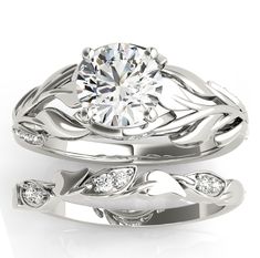 a white gold wedding ring set with leaves and diamonds