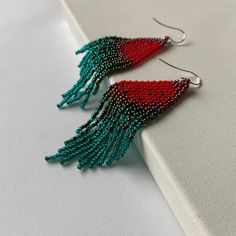 "These boho chic red-turquoise beaded earrings are made of high quality Czech beads. Colors: red, burgundy, dark green, turquoise. -------------------------------------------- ✦ The Details: ✔ Made with quality Czech beads ✔ Made using strong bead weaving thread. ✔ Lenght: app. 3.9 inches ✔ Sterling silver earrings hooks There may be some color discrepancies which is due to the different monitor settings ✦ All earrings hooks are nickel and lead free! ✦ More great boho earrings found here https:/ Red Bohemian Tassel Earrings As Gift, Bohemian Burgundy Beaded Jewelry, Red Bohemian Beaded Earrings, Red Tassel Earrings With Fringe And Round Beads, Red Fringe Tassel Earrings With Round Beads, Red Bohemian Beaded Earrings With Tassels, Red Bohemian Beaded Earrings With Colorful Beads, Bohemian Red Beaded Earrings With Tassels, Bohemian Red Beaded Earrings With Colorful Beads