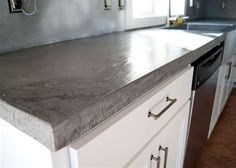 a counter top in a kitchen with white cabinets