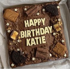 a birthday cake with the words happy birthday kate spelled in chocolate frosting and cookies