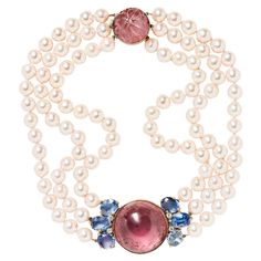 Composed of three strands of cultured pearls suspending a luscious cabochon pink tourmaline flanked by sapphires and diamonds, this ladylike choker casts a luminous glow on the skin. The thoughtful design terminates in a carved pink tourmaline clasp. Internal circumference is approximately 15.25” Pearls measure approximately 8.4 to 8.9 mm Signed Seaman Schepps White Coral Necklace, Victorian Choker Necklace, Seaman Schepps, Necklaces Choker, Vintage Choker Necklace, Formal Jewelry, Cognac Diamonds, Pearl And Diamond Necklace, Vintage Choker