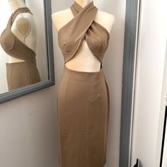 a mannequin with a dress on display in front of a mirror