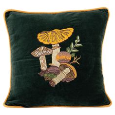 a green pillow with mushrooms on it