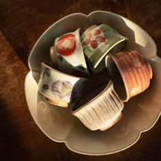 a white bowl filled with lots of different colored dishes