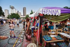 many people are shopping at an outdoor flea market