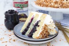 a slice of cake on a plate next to a can of blueberry compote