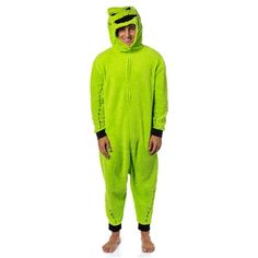 a man in a green animal onesuit is smiling at the camera while standing up