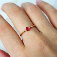 A simple 14k gold-filled or sterling silver band encrusted with your choice of birthstone Ruby gemstone in the center! ∙ Gift Ready in a jewelry box! ∙ Handmade in Vancouver, Canada.  ∙ 100% 14k Gold Fill or Sterling Silver ∙ Rings Sold Individually Please note: All stones due to its nature will vary in colour, flash and hue! --------------------------------- M E A S U R E M E N T :  Width: 1.25mm  Gemstone: 4mm  Size: Optional (US measurement) If your ring size is not specified as an option, pl Simple Design Birthstone Ring In Fine Jewelry Style, Minimalist Yellow Gold Ruby Birthstone Ring, 14k Gold Filled Gemstone Ring, Simple Round Birthstone Ring Fine Jewelry, Simple Round Birthstone Ring In Fine Jewelry Style, Minimalist Round Gemstone Birthstone Ring, Minimalist Ruby Ring Birthstone, 14k Gold Minimalist Ruby Birthstone Ring, Minimalist Ruby Ring With Birthstone