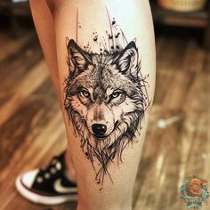 a tattoo on the leg of a woman with a wolf head and watercolor splashes