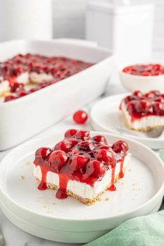 a piece of strawberry cheesecake on a plate with strawberries next to the cake