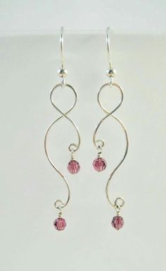 pair of silver earrings with pink crystal beads