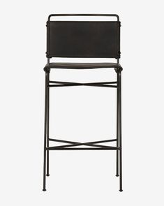 an iron bar stool with black leather upholstered back and seat, on a white background