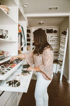 a woman standing in front of a white counter