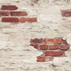 an old brick wall that has been painted white and red with some rust on it