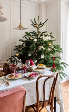 a dining room table set for christmas dinner