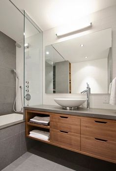 a bathroom with a sink, mirror and bathtub next to a walk in shower