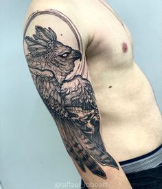 a man's arm with a bird tattoo on it and an arrow in the middle