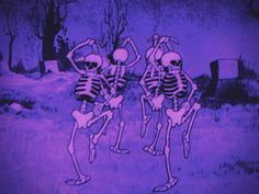 two skeletons dancing in front of a cemetery