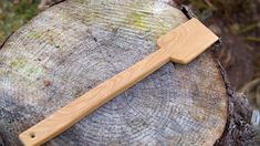 a wooden knife sitting on top of a tree stump