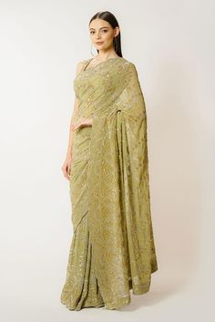 Olive green georgette saree with sequins and cutdana hand embroidery. Comes with a blouse.
Components: 2
Pattern: Hand embroidered
Type Of Work: Sequins, Cutdana
Neckline: Round
Sleeve Type: Sleeveless
Fabric: Georgette
Color: Green
Other Details: 
Closure: Blouse - Back hooks and tie-up
Occasion: Wedding - Aza Fashions Green Georgette Saree, Embroidered Saree, Green Saree, Georgette Saree, Blouse For Women, Green Sequins, Saree With Blouse, Georgette Sarees, Blouse Online