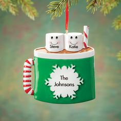 a christmas ornament with two coffee mugs on it and the words steve and kate