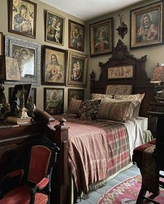 a bed sitting in a bedroom next to a bunch of pictures on the wall above it