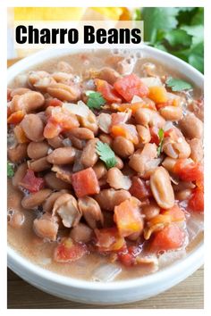 a white bowl filled with beans on top of a wooden table