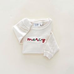 Custom Embroidered Festive Child Corded Crewneck (Cursive) Red & Green Embroidery Lightweight Corded Crewneck 100% Cotton Personalized just for you! Please enter personalization above. *PERSONALIZATION DETAILS: All Lower Case Type Only. No Special Characters. Maximum of 10 characters Garment will be embroidered exactly as typed in lower case. Please double check before ordering, as changes cannot be made after order is submitted. *SIZING: Roomy fit. Ordering your child's normal size is recommended. Please refer to the size chart. *CARE: Gentle wash in cold water. Lay flat to dry. *PROCESSING TIME: 5-7 Business Days. Thank you for shopping Merce & Co. Find us on Instagram @merceandcompany to stay up to date on new arrivals and sales! Personalized items are final sale. Returns and exchanges Festive Cotton Tops For Fall, Cream Tops With Letter Embroidery For Fall, Winter Embroidered Sweater For Loungewear, Holiday Embroidered Tops For Fall, Festive Long Sleeve Cotton Sweater, Winter Embroidered Tops For Loungewear, Cream Tops With Embroidered Text For Fall, Cream Letter Print Top For Winter, Cream Winter Top With Letter Print