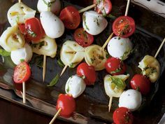 several skewers of food with tomatoes and mozzarella