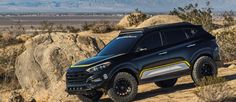 a black and yellow truck parked in the desert