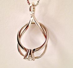 "When the large size is sold out please see: https://www.etsy.com/alicart/listing/904244385 The Ring Holder Necklace, also called a Wedding Ring Holder or Engagement Ring Holder, is a great way to wear rings when you can't have them on your hands. With the Isla, your ring becomes a part of the design. Now you can choose the original Isla or the larger Isla. Ring necklace holders are also a meaningful way to wear the ring of someone dear to you. Choice of Isla size and chain length in Variations Sterling Silver Wedding Jewelry With Ring Detail, White Gold Jewelry Ring Detail For Gift, White Gold Jewelry With Unique Design For Wedding, White Gold Wedding Jewelry With Unique Design, Sterling Silver Jewelry With Unique Design For Anniversary, Unique Oval Wedding Jewelry, Unique Oval Design Jewelry For Anniversary, Oval Jewelry With Unique Design For Anniversary, Sterling Silver Wedding Pendant Rings