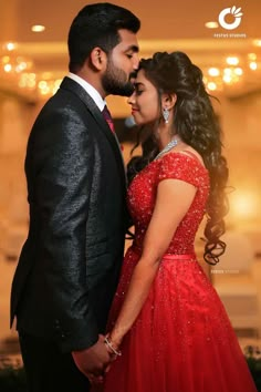 a man in a suit and woman in a red dress