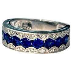 a blue and white ring with diamonds on it