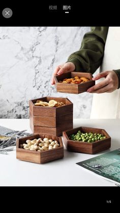 three wooden boxes filled with different types of food on top of a white countertop