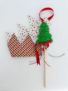 two paper crowns and a christmas tree on a stick