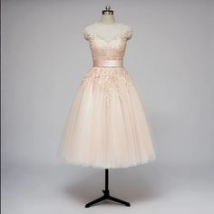 a dress on a mannequin with a pink sash