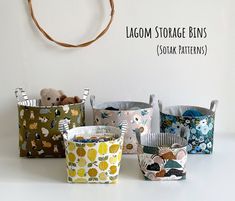 several small storage bins are lined up against a wall with the words, lagom storage bins soak patterns