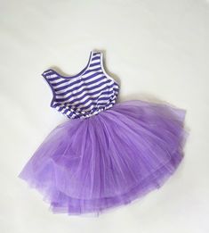 -Round neckline -Soft Cotton -Purple/ White stripes -Tank Style -Purple Tulle Skirt -Elastic band at the waist. -Detachable ribbon bow -Inner lining short skirt -Runs big -model is 15m. wearing 12-18m (with plenty of room to grow into) Care Instructions: Hand Wash or Machine wash low cycle with cold/ warm water. Hang dry. Purple Baby Dress, Purple Tulle Skirt, Baby Tutu Dress, Baby Tutu Dresses, Purple Tulle, Baby Tutu, Purple Baby, Baby First Birthday