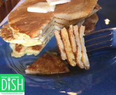 pancakes with butter and syrup on a blue plate